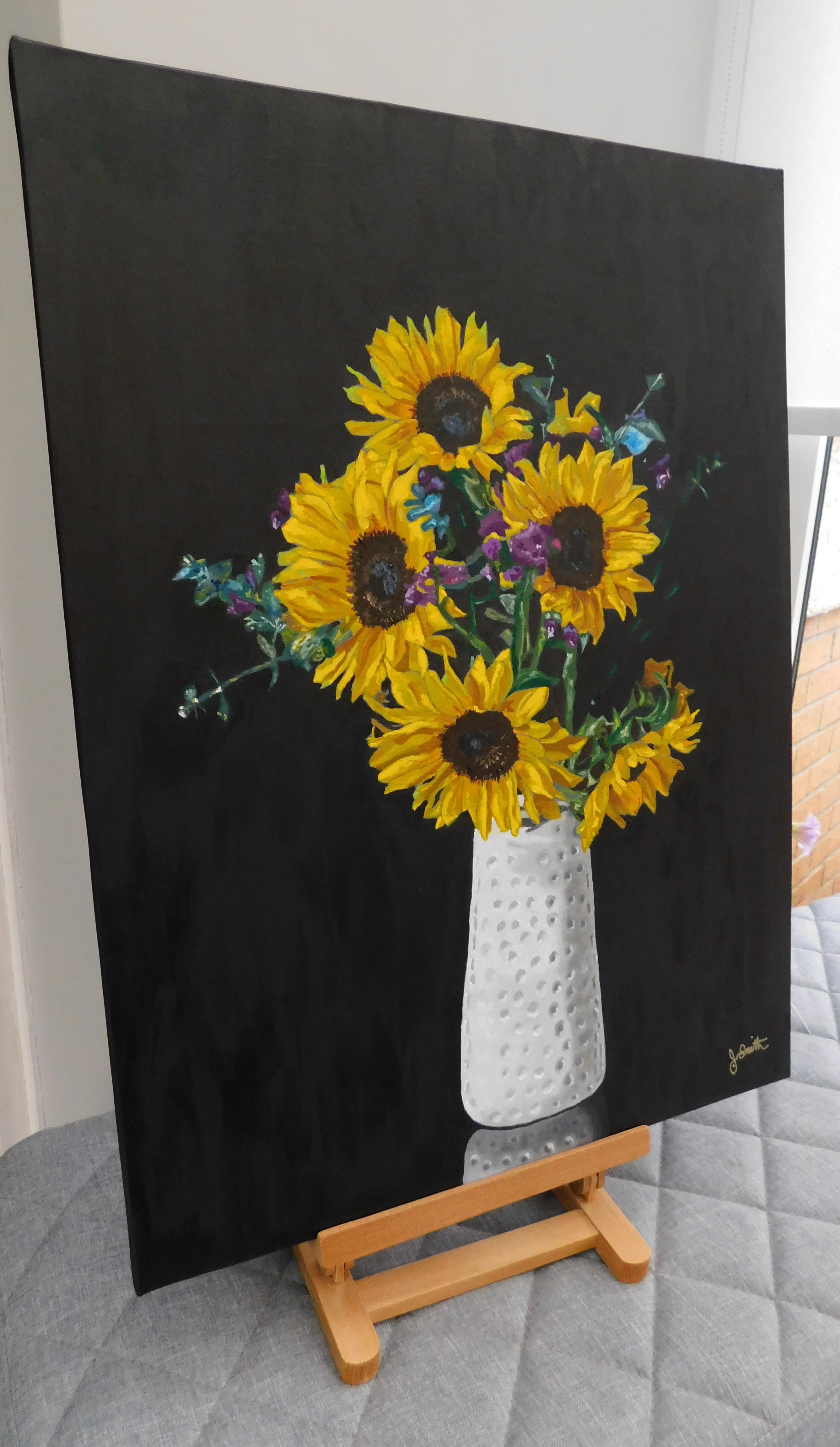 Five sunflowers in a white vase - on an easel